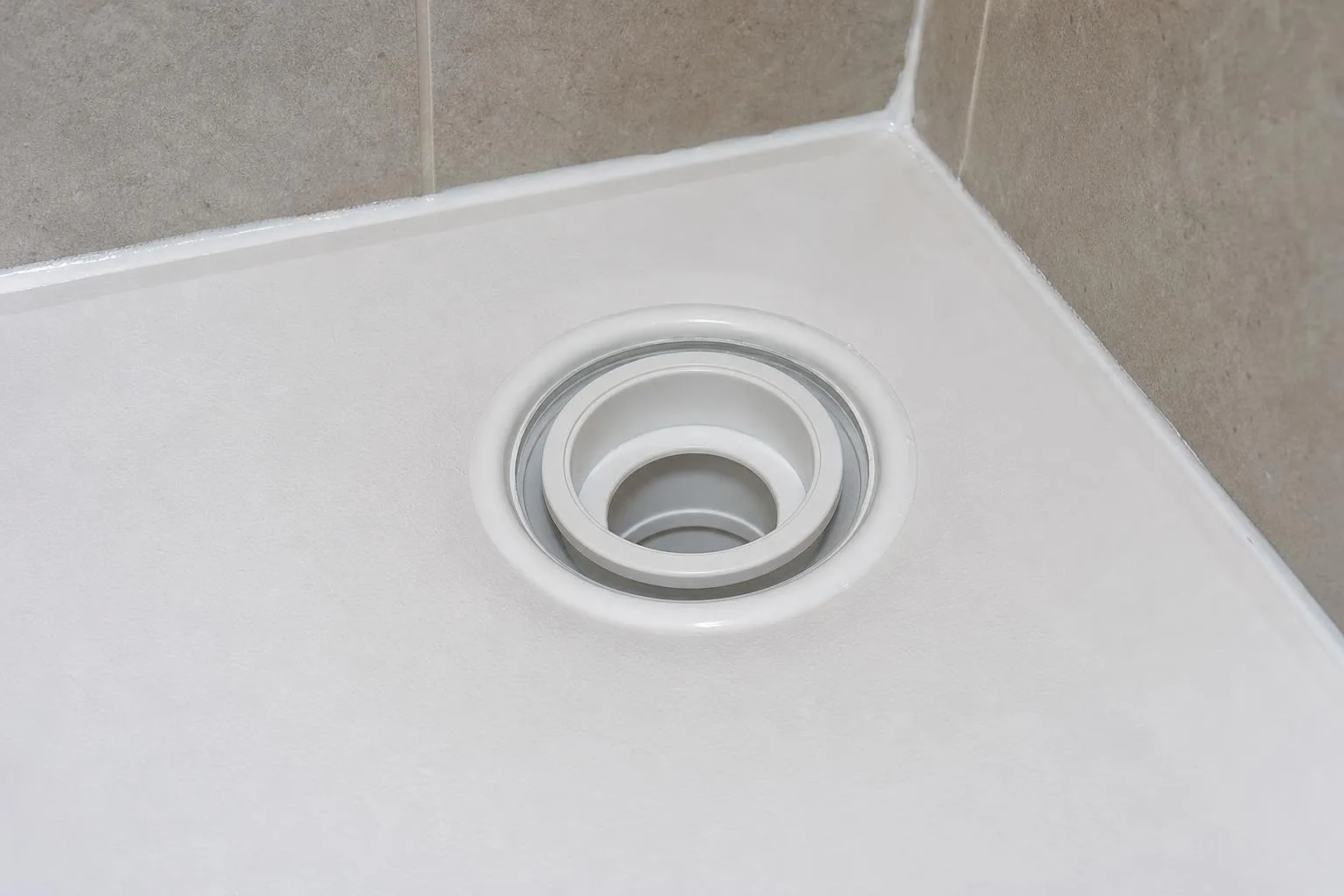 Detalle del desagüe de una ducha con rejilla de acero